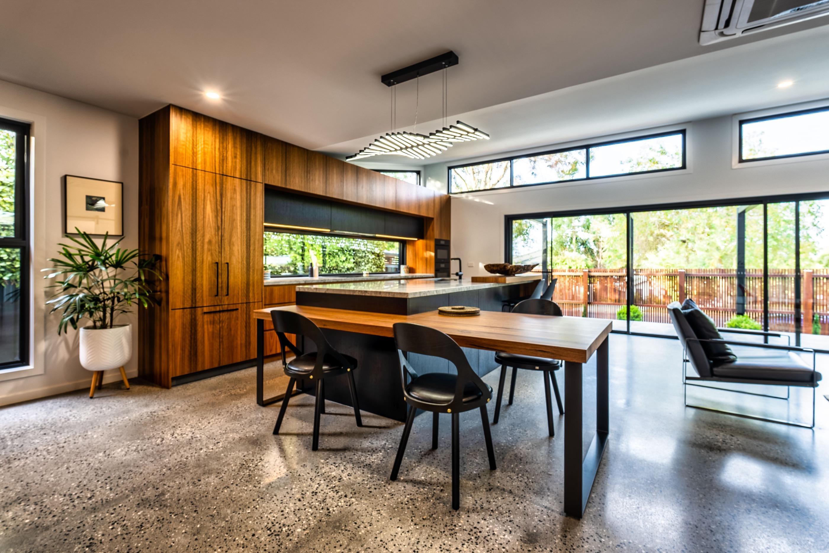 Cocina con carpintería de madera oscura y suelo pulido